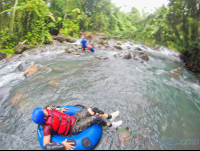 Lady Floating On A Tube Getting Ready To Enter The Rapids Blue River Rincon De La Vieja
 - Costa Rica
