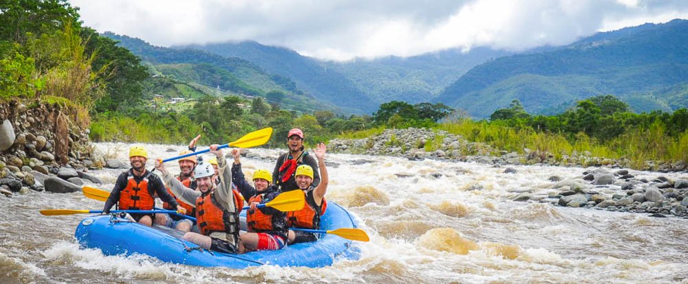        grande de orosi whitewater rafting rafting with mountain background
  - Costa Rica